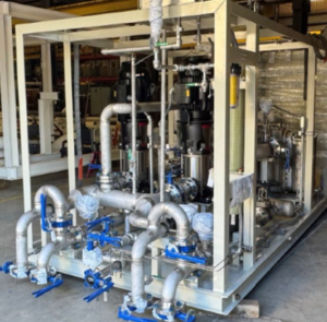 Industrial pump system with stainless steel pipes and valves.